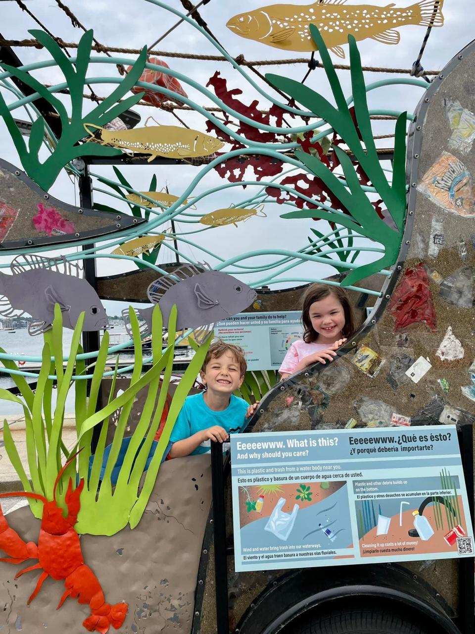 Jack Barrett, 4, and Harper Barrett, 8, learn about ocean pollution during #OceanHour Week at Fort Adams State Park on Sunday, June 12, 2022.