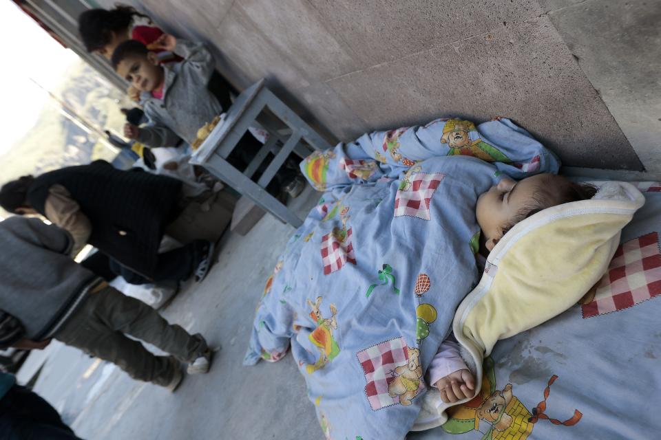 An ethnic Armenian child from Nagorno-Karabakh sleeps on the ground after arriving in Armenia's Goris in Syunik region, Armenia, Thursday, Sept. 28, 2023. The separatist government of Nagorno-Karabakh announced Thursday that it will dissolve itself and the unrecognized republic will cease to exist by the end of the year, and Armenian officials said more than half of the population has already fled. (AP Photo/Vasily Krestyaninov)