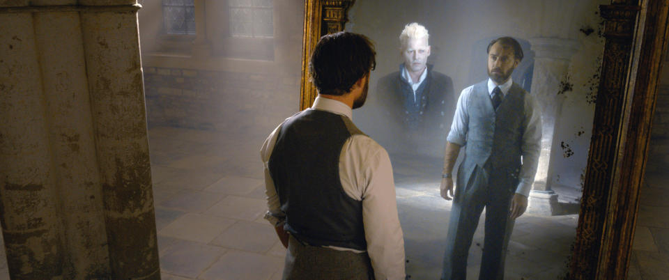 Dumbledore (Jude Law) sees his heart's desire, Grindelwald (Johnny Depp) reflected in the Mirror of Erised in 'Fantastic Beasts: The Crimes of Grindelwald'.  (Photo: Warner Bros. Entertainment Inc./Courtesy Everett Collection)