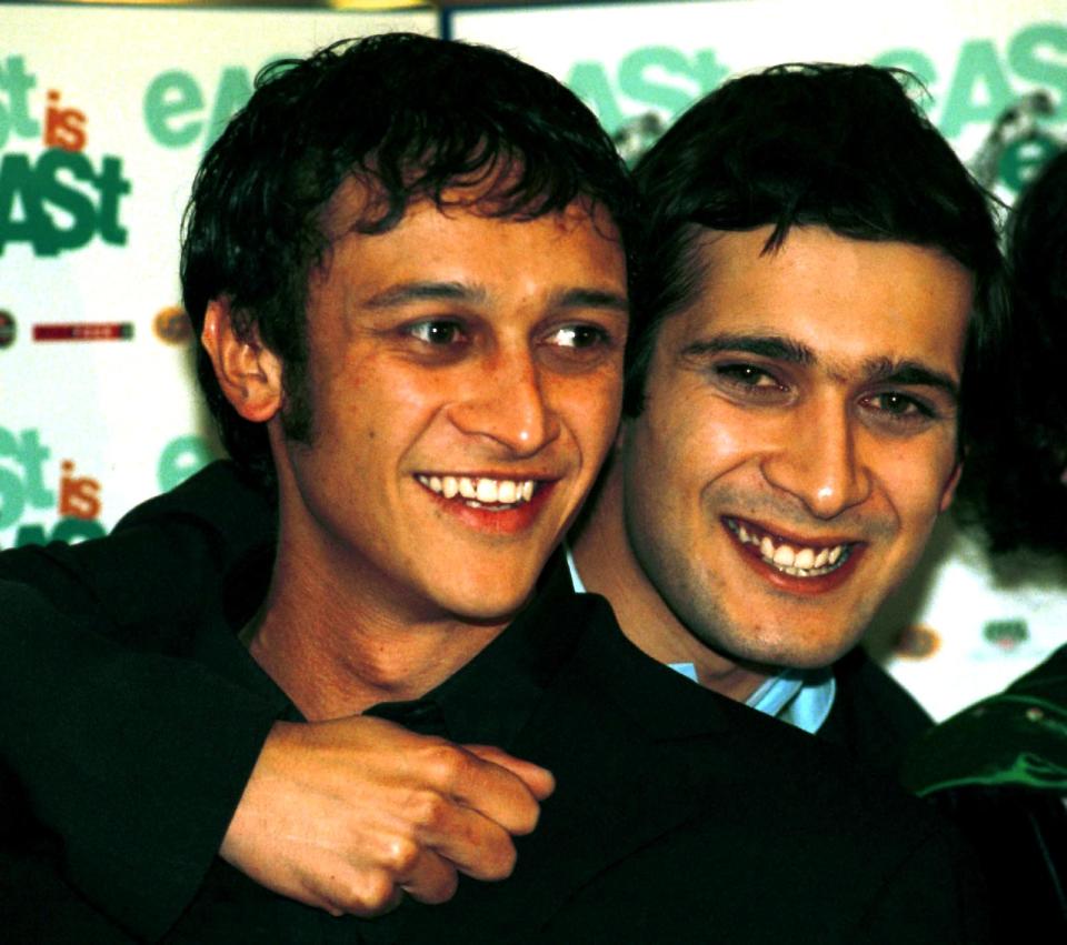 Actors Chris Bisson (left), of television soap Coronation Street, and Jimi Mistry, of Eastenders, attend the World Premiere of their film "East is East" at the Trafford Centre in Manchester.   (Photo by Peter Wilcock - PA Images/PA Images via Getty Images)