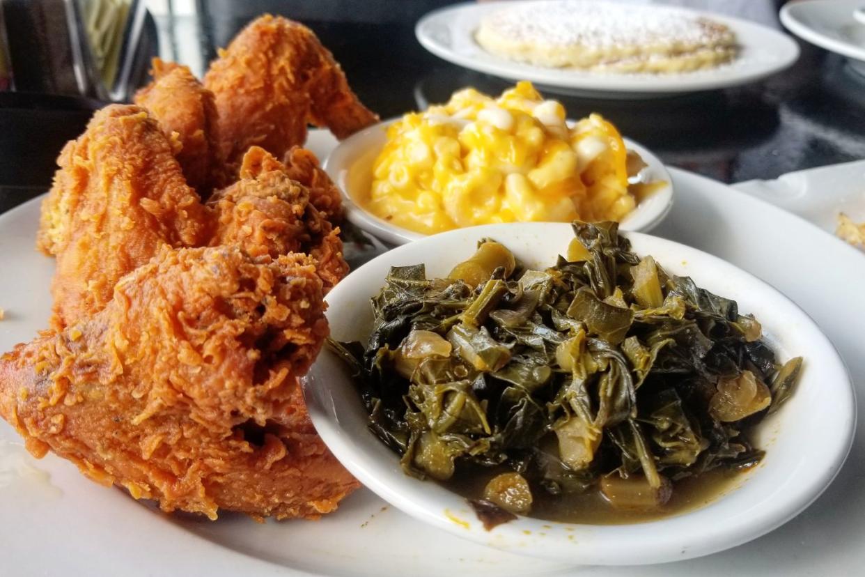 soul food plate with chicken, macaroni and cheese, and collard greens