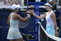 Ashleigh Barty, left, of Australia, and Elina Svitolina, of Ukraine, meet at the net after their semifinal at the Miami Open tennis tournament Thursday, April 1, 2021, in Miami Gardens, Fla. Barty won 6-3, 6-3. (AP Photo/Lynne Sladky)