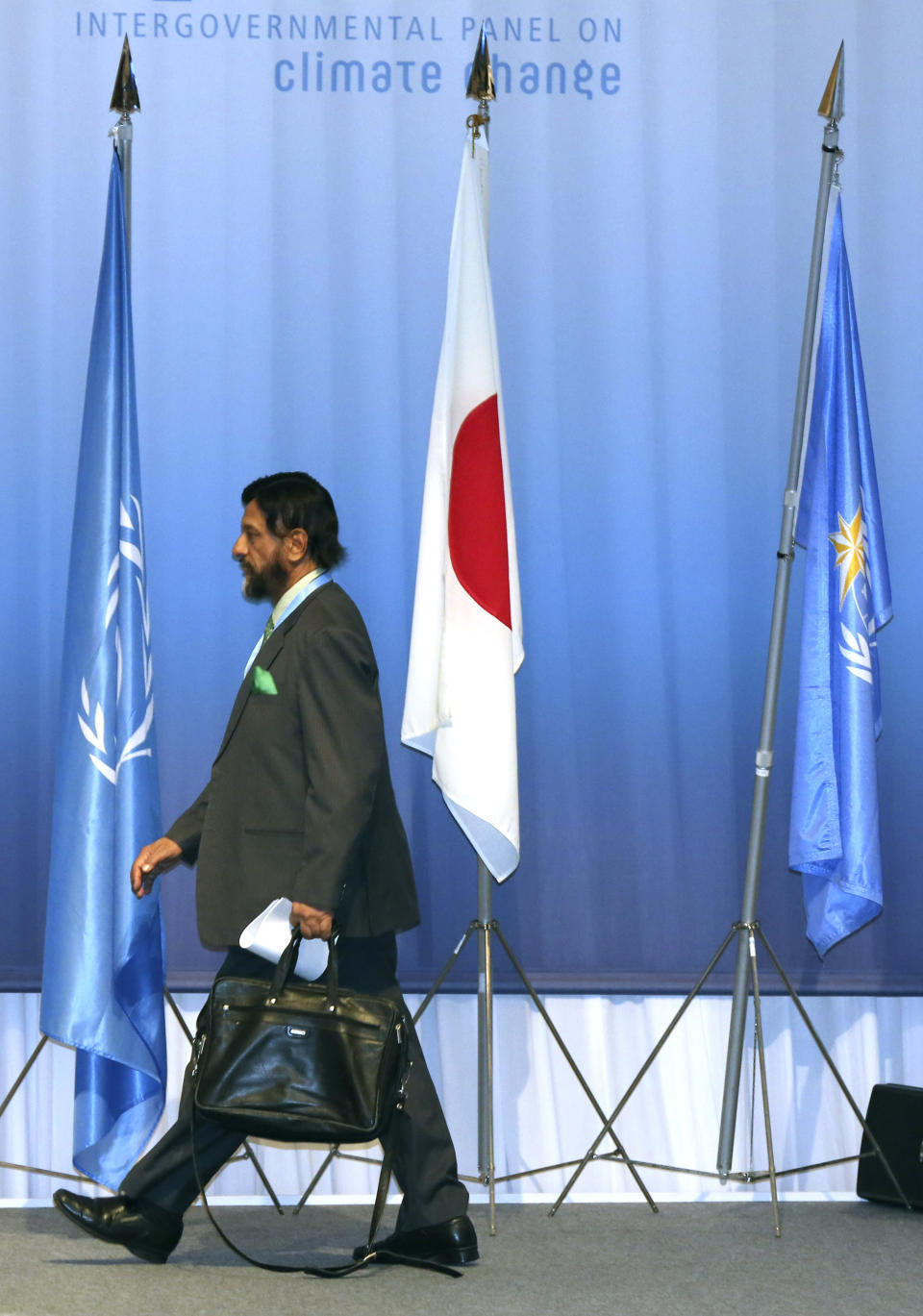 The chair of the Intergovernmental Panel on Climate Change (IPCC) Rajendra K. Pachauri walks in the venue during the opening session of the 10th Plenary of IPCC Working Group II and the 38th Session of the IPCC in Yokohama, Tuesday, March 25, 2014. The hundreds of scientists from 100 countries meeting in this Japanese port city are putting finishing touches on a massive report emphasizing the gravity of the threat the changing climate poses for communities from the polar regions to the tropics.(AP Photo/Eugene Hoshiko)