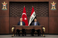 Iraq's Prime Minister Mohammed Shia al-Sudani, right, and Turkey's President Recep Tayyip Erdogan sit together during their meeting in Baghdad, Iraq, Monday April 22, 2024. (Ahmad Al-Rubaye/Pool via AP)