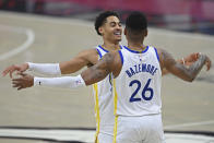 Golden State Warriors' Jordan Poole (3) and Kent Bazemore (26) celebrate after a basket in the second half of an NBA basketball game against the Cleveland Cavaliers, Thursday, April 15, 2021, in Cleveland. (AP Photo/David Dermer)