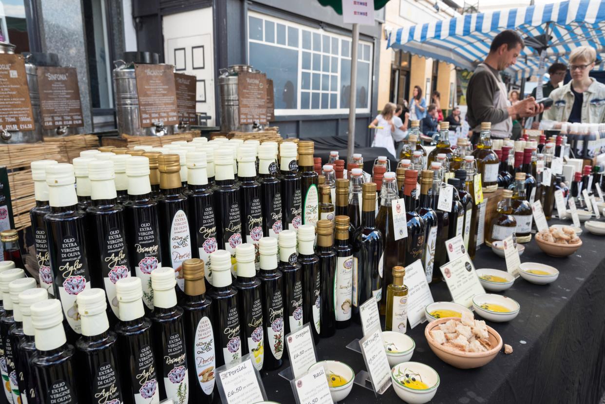 Italian extra virgin olive oil on stall at Broadway Market, Hackney, London, UK