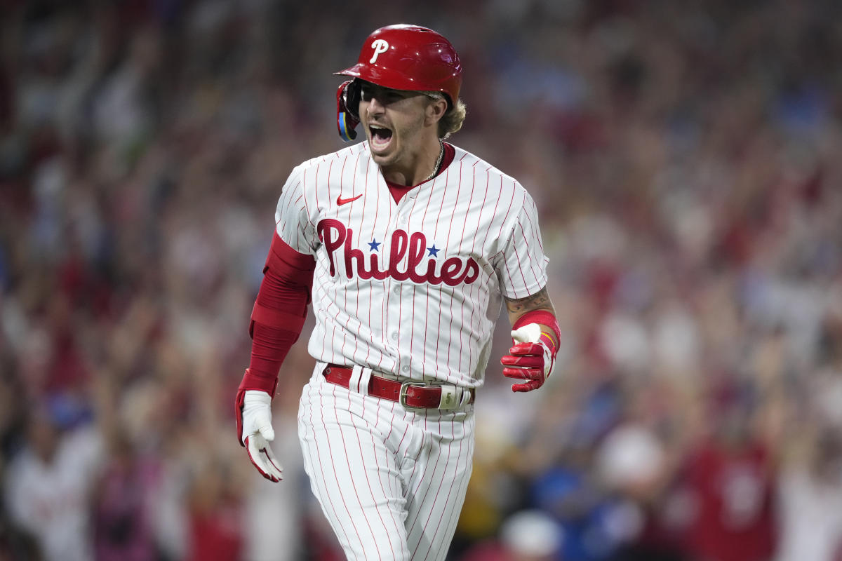 Philadelphia Phillies - The team celebrating winning today's game. They are  wearing white Phillies uniforms and hugging Bryson Stott.