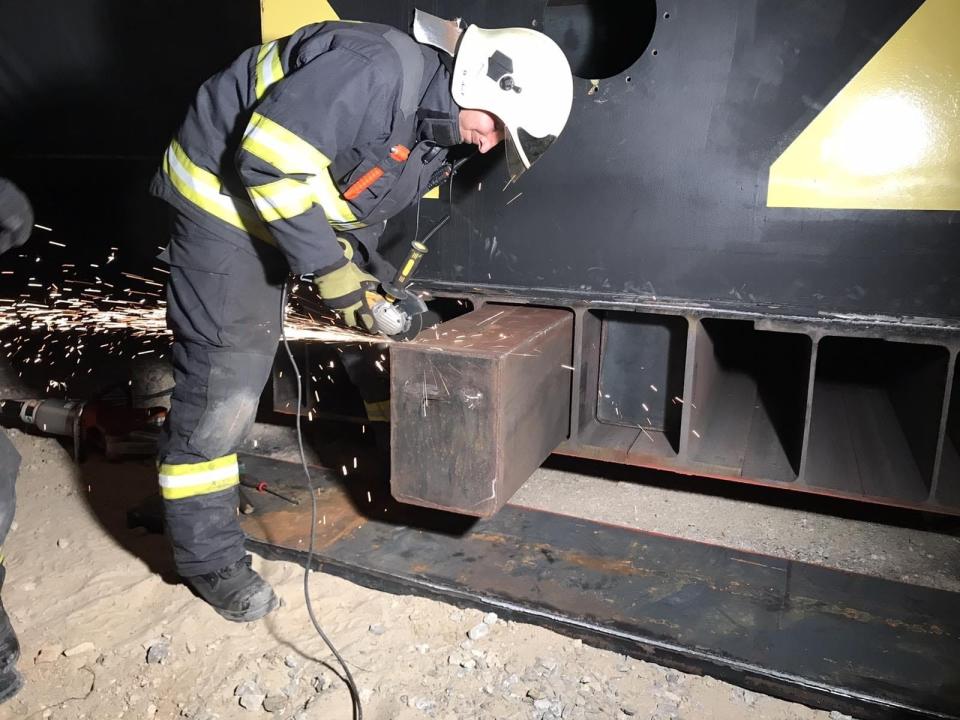 In this handout photo taken in May, 2020, a custom officers opens a container in search of drugs. Authorities in Slovakia say they have seized 1.5 tons of methamphetamines, with an estimated street value of some 2 billion euros ($1.7 billion), which was being smuggled into the country and originated in Mexico. Officials said Tuesday July 7, 2020, that the drugs were found at the end of May with the help of Hutch, a service dog employed by the country's financial administration, after customs officials became suspicious about the contents of two large metal containers for transporting liquids. (AP Photo/HO Photo by Slovakia's Custom Office)