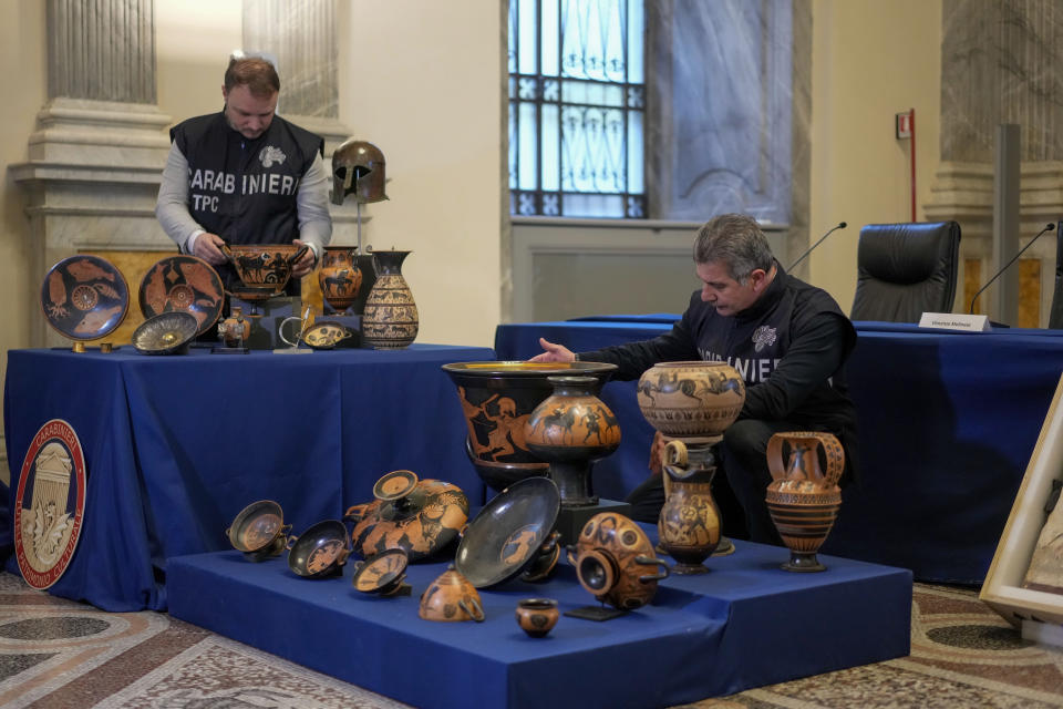Carabinieri police officers put on display 60 archaeological artifacts stolen from Italy and sold in the US by international art traffickers are seen on display during a press conference in Rome, Monday, Jan. 23, 2023. The stolen artifacts, for an estimated total value of 20 million dollars, have been recovered in private collections in the US and returned to Italy after a joint investigation by Italian Carabinieri police and the New York County District Attorney's Office. (AP Photo/Andrew Medichini)