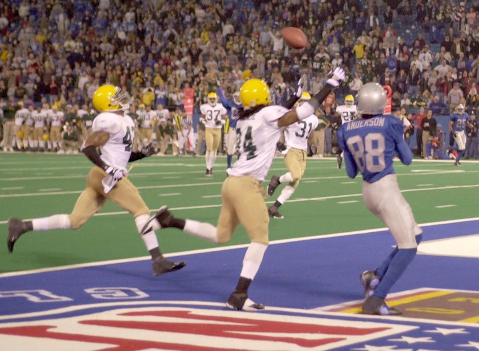 Detroit Lions receiver Scotty Anderson pulls in a touchdown pass over the arms of the the Green Bay Packers' Mike McKenzie in the final seconds of the game on Thursday, Nov. 22, 2001. The score brought the Lions to within two points, but the conversion attempt failed.