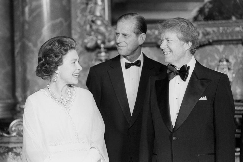 President Jimmy Carter joins Queen Elizabeth II and the Duke of Edinburgh at Buckingham Palace when he and six other world leaders attended dinner in the Blue Drawing Room. / Credit: PA Images/Contributor/Getty
