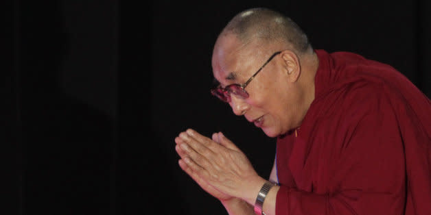 Tibetan spiritual leader the Dalai Lama greets the audience as he arrives to speak on "A Human Approach to World Peace" at Presidency College in Kolkata, India, Tuesday, Jan. 13, 2015. (AP Photo/Bikas Das) (Photo: )