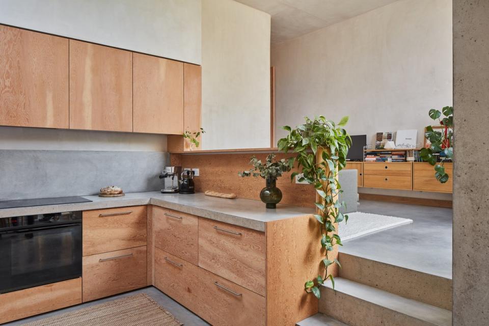 Douglas fir cabinetry accents the polished concrete floor (Juliet Murphy)