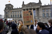 Students protest under the banner of 'Fridays for Future' in front of the Reichstag building, host of the German Federal Parliament, in Berlin, Germany, Friday, Dec. 14, 2018 against the climate change. (AP Photo/Michael Sohn)