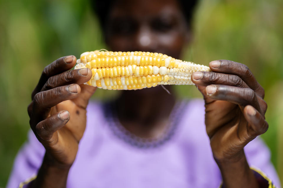 Malita Mussa holds a malformed maize cob outside her home in the village of Manduwasa (Brian Lawless/PA)