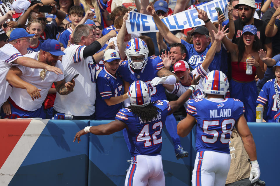 Buffalo Bills linebacker Terrel Bernard, center, celebrates with fans and teammates Dorian Williams (42) and Matt Milano (58) after intercepting a pass during the first half of an NFL football game against the Las Vegas Raiders, Sunday, Sept. 17, 2023, in Orchard Park, N.Y. (AP Photo/Jeffrey T. Barnes)