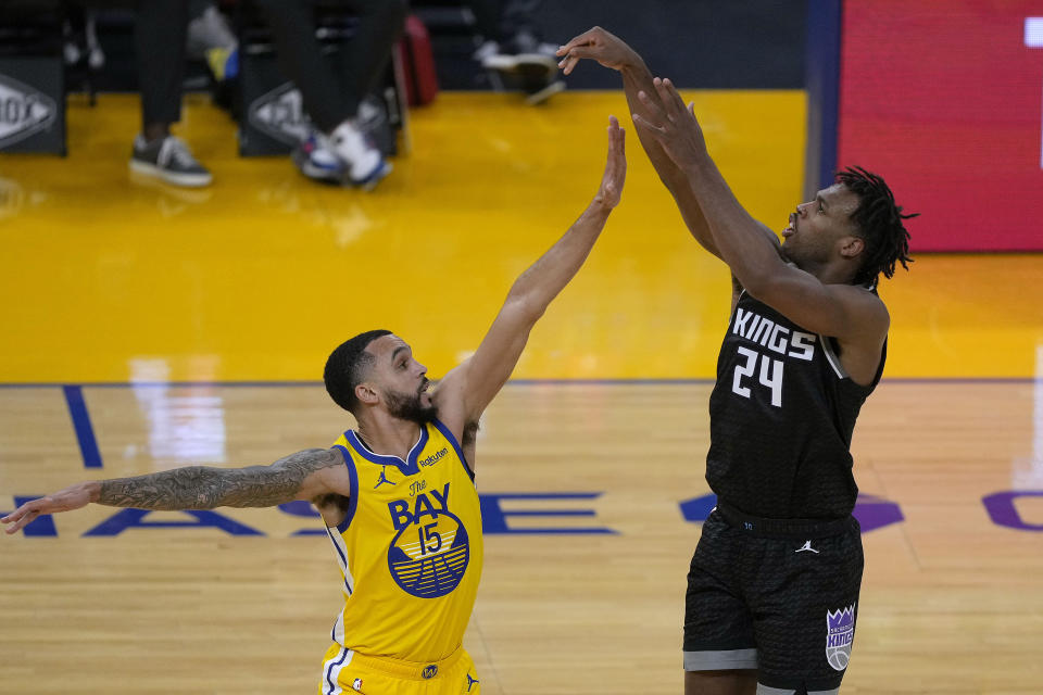 Sacramento Kings guard Buddy Hield (24) shoots a 3-point shot over Golden State Warriors guard Mychal Mulder (15) during the second half of an NBA basketball game on Sunday, April 25, 2021, in San Francisco. (AP Photo/Tony Avelar)