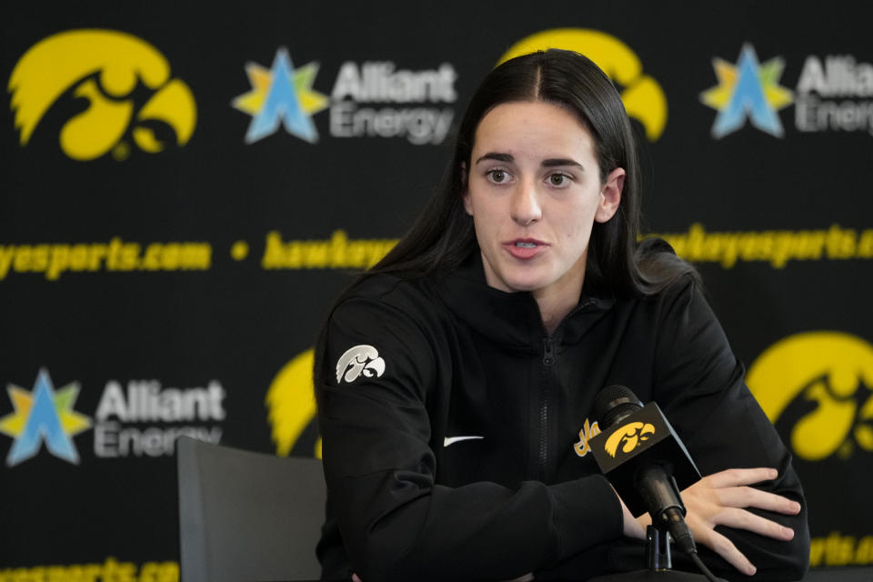 Iowa guard Caitlin Clark speaks to reporters during Iowa's NCAA college basketball media day Oct. 4, 2023, in Iowa City, Iowa. Clark is embracing her role as an ambassador for the game after she led Iowa to the NCAA championship game last season. She enters this season with 90 straight double-figure scoring games and a 27.3-point career average. (AP Photo/Charlie Neibergall)