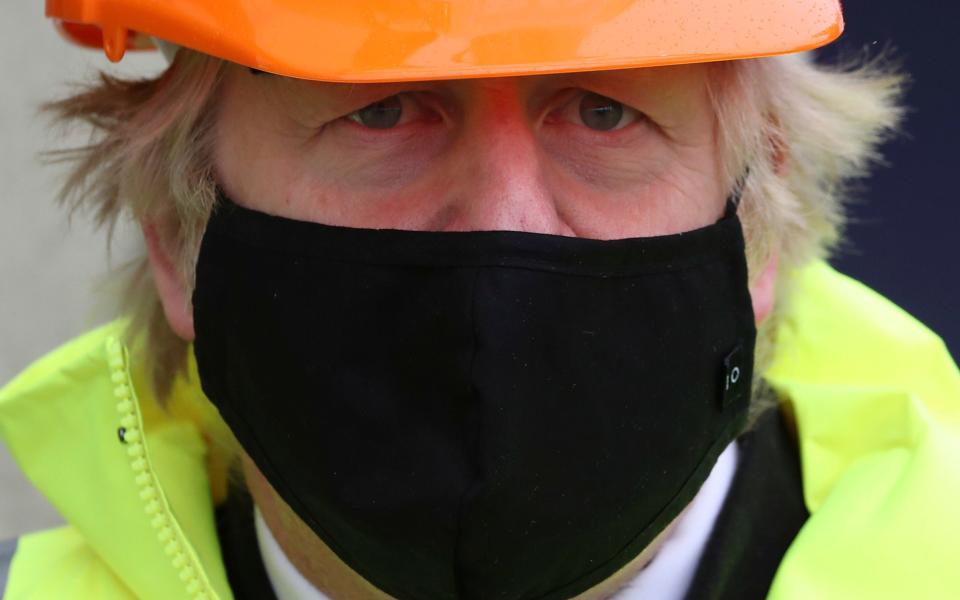 Boris Johnson wears a hard hat and mask during a visit to Teesport in Middlesbrough - PA