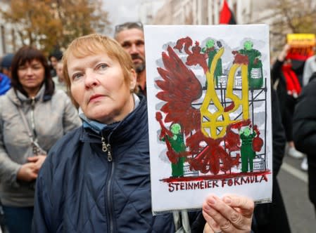 People attend a rally against approval of so-called Steinmeier Formula, in Kiev