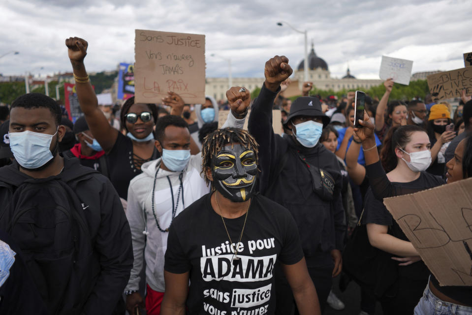 People demonstrate in Lyon, central France, Saturday, June 6, 2020, to protest against the recent killing of George Floyd by police officers in Minneapolis, USA, that has led to protests in many countries and across the US. Further protests are planned over the weekend in European cities, some defying restrictions imposed by authorities due to the coronavirus pandemic. (AP Photo/Laurent Cipriani)