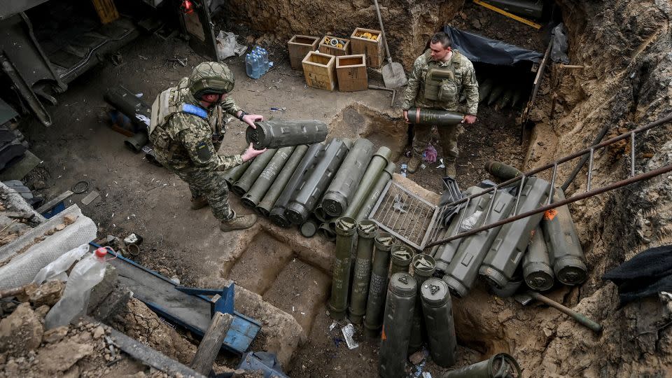 Ukrainian service members prepare shells next to a self-propelled howitzer at a position near a front line in Zaporizhzhia region, Ukraine, on April 3, 2024. - Reuters