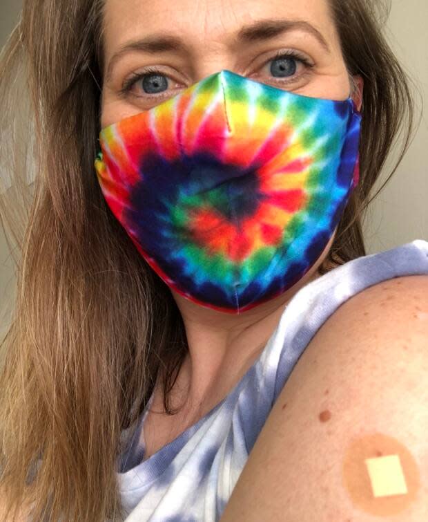 Betsy Hilton, 42, posted this photo of herself on Twitter after getting the first dose of AstraZeneca and said in a tweet: 'Huge thanks to science. To #AstraZenaca. To the healthcare community. And to my awesome local pharmacy.' She added: 'Walking to the pharmacy, listening to Beastie Boys ‘Sure Shot’. #vaxjam #AstraZenaca #GenX' (Submitted by Betsy Hilton - image credit)