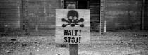 A wooden sign with the word STOP stands in front of what was an electric barbed wire fence inside the former Nazi death camp of Auschwitz I, in Oswiecim, Poland, Sunday, Dec. 8, 2019. Auschwitz was the largest of the Germans' extermination and death camps and has become a symbol for the terror of the Holocaust. On January 27, 2020 _ 75 years after its liberation _ hundreds of survivors from across the world will come back to visit Auschwitz for the official anniversary commemorations. (AP Photo/Markus Schreiber)