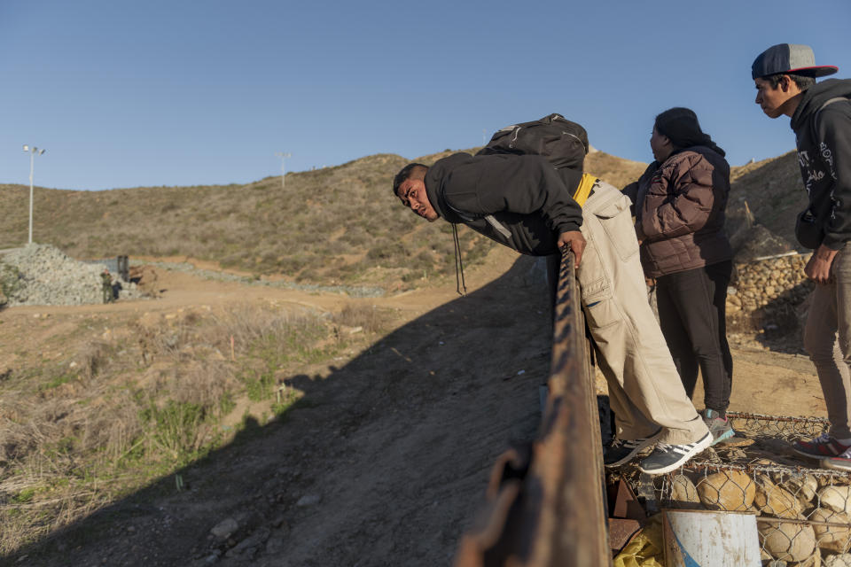 A migrant from Honduras looks from the border fence into the U.S. side before jumping to San Diego, Calif., from Tijuana, Mexico, Thursday, Jan. 3, 2019. Discouraged by the long wait to apply for asylum through official ports of entry, many migrants from recent caravans are choosing to cross the U.S. border wall and hand themselves in to border patrol agents. (AP Photo/Daniel Ochoa de Olza)