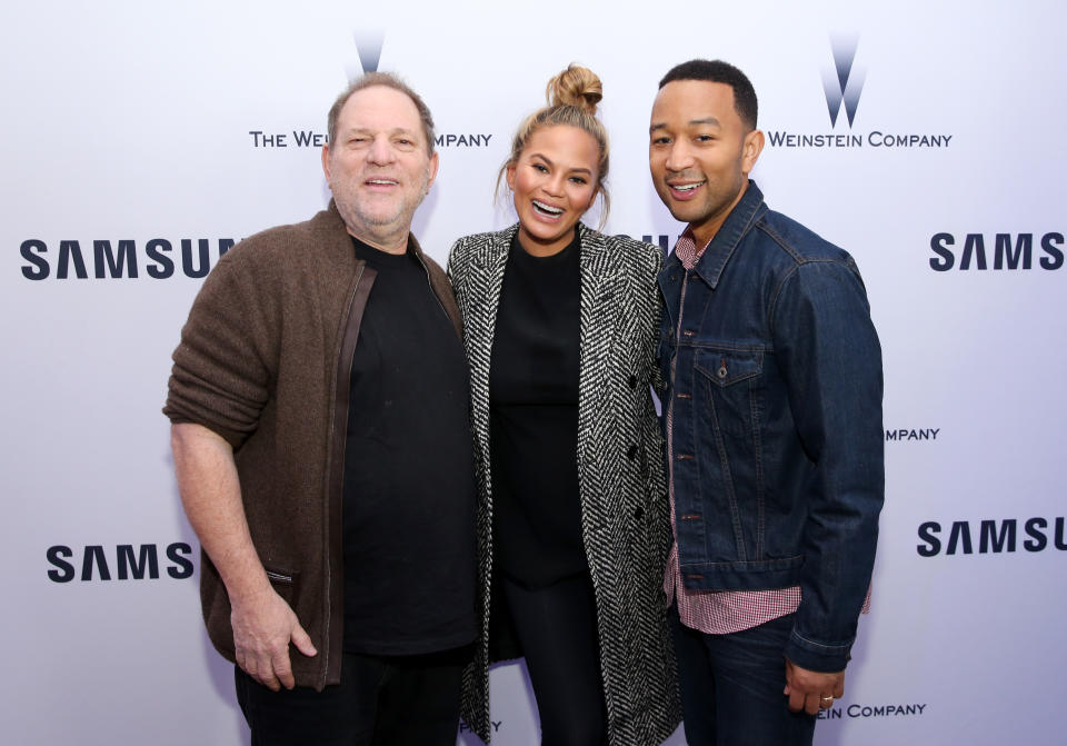 The photo that some R. Kelly fans are slamming John Legend for, taken in 2016 at the Sundance Film Festival, shows the singer with Harvey Weinstein as well as Legend’s wife, Chrissy Teigen. (Photo: Getty Images)