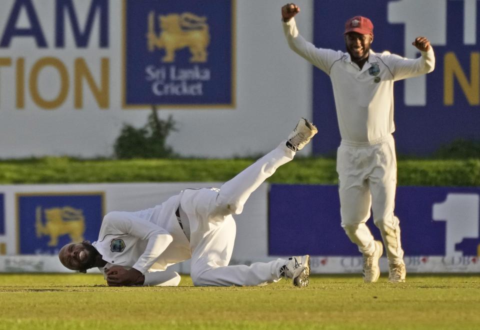 West Indies bowler Roston Chase takes a catch to dismiss Sri Lanka's Dimuth Karunaratne during the day one of their second test cricket match in Galle, Sri Lanka, Monday, Nov. 29, 2021. (AP Photo/Eranga Jayawardena)