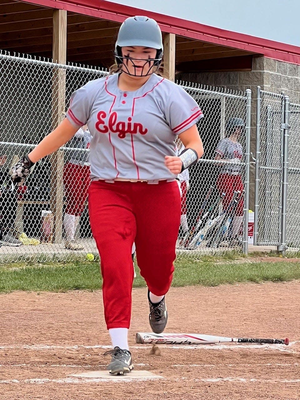 Elgin's Emilie Bishop scores a run during a Tuesday softball game at home against Perry.