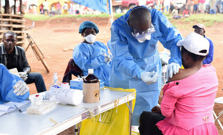 FILE PHOTO: A Congolese health worker administers Ebola vaccine to a woman who had contact with an Ebola sufferer in the village of Mangina in North Kivu province of the Democratic Republic of Congo, August 18, 2018. REUTERS/Olivia Acland/File Photo