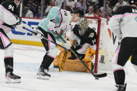 Pacific Division's Elias Pettersson, of the Vancouver Canucks (40) tries to get a shot off on Central Division's goaltender Juuse Saros, of the Nashville Predators (74) during first period of the NHL All Star hockey game, Saturday, Feb. 4, 2023, in Sunrise, Fla. (AP Photo/Lynne Sladky)