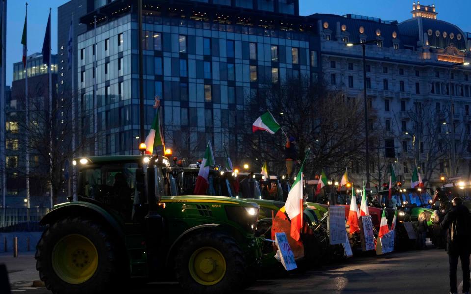 Italian farmers arrive with their tractors at the Pirelli skyscraper, seat of the Lombardy Regional Council, during a protest in Milan