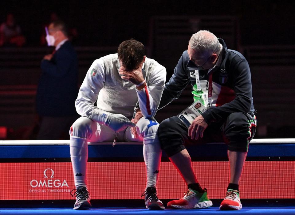 <p>Italy's Daniele Garozzo is consolate by his coach Fabio Maria Galli after loosing against Hong Kong's Cheung Ka Long on July 26 in the mens individual foil fencing gold medal match.</p>