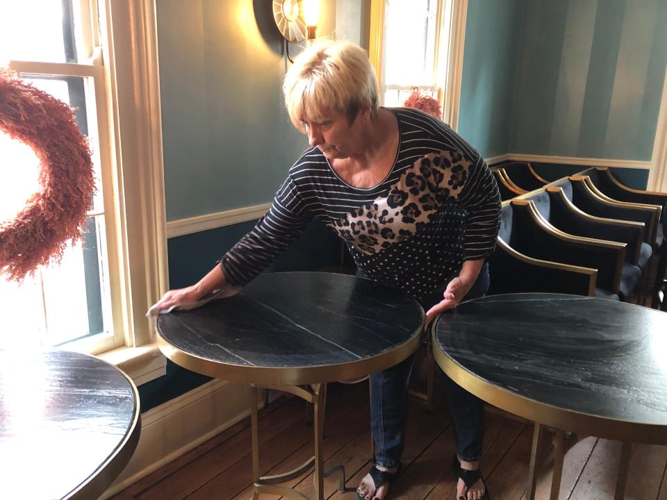 Buxton Inn employee Arlena Dean cleans tables inside Granville's Buxton Inn Feb. 21 as the historic site continues to recover from an Oct. 25 fire. The inn is expected to reopen to overnight guests in April.
