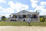 People take shelter at the Apostolic Church of Tagabe in Port Vila on March 20, 2015 after Cyclone Pam devastated Vanuatu