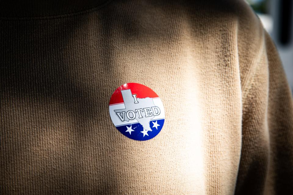 A man wearing a voting sticker leaves the Nueces County Courthouse after voting in the Primary Election on Tuesday, Feb. 20, 2024, in Corpus Christi, Texas. Tuesday was the first day of early voting.