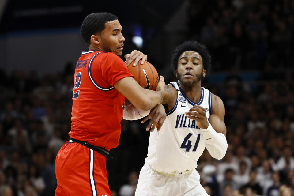 St. John's Julian Champagnie (2) and Villanova's Saddiq Bey (41) battle for the ball during the first half of an NCAA college basketball game, Wednesday, Feb. 26, 2020, in Villanova, Pa. (AP Photo/Matt Slocum)