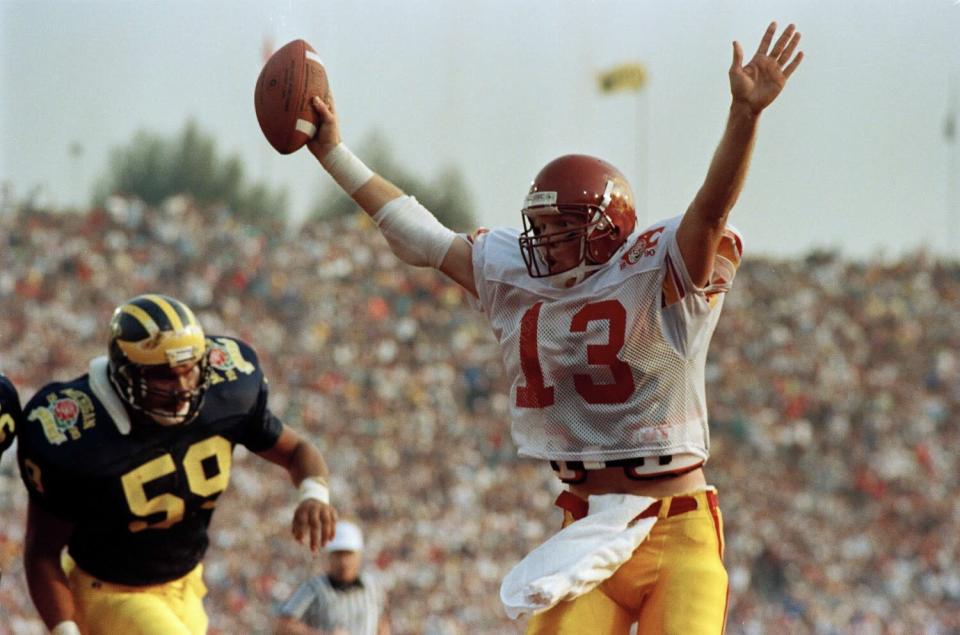 USC's quarterback Todd Marinovich celebrates as he scores a touchdown against Michigan.