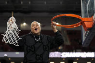 South Carolina head coach Dawn Staley celebrates cutting the net after their win against LSU in an NCAA college basketball game at the Southeastern Conference women's tournament final Sunday, March 10, 2024, in Greenville, S.C. (AP Photo/Chris Carlson)