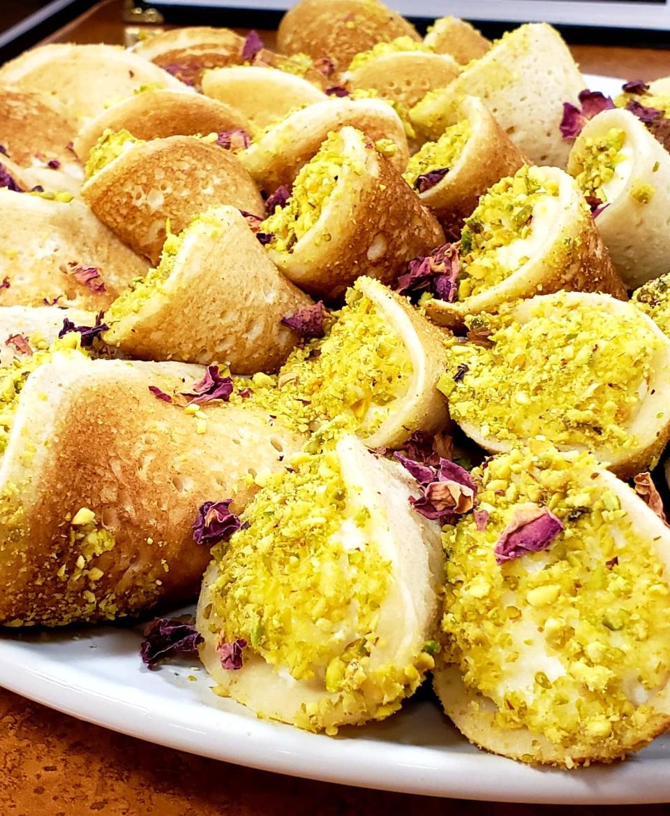 Qatayef, a sweet rolled dessert filled with cream and nuts.