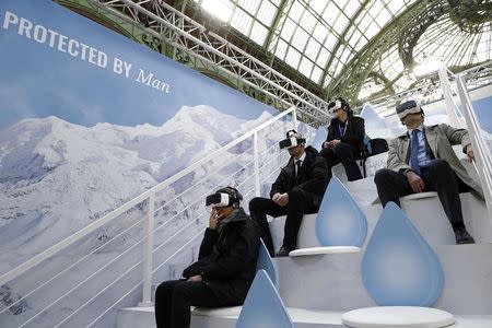 Visitors look through 3D goggles during their visit to the Solutions COP21 event at the Grand Palais in Paris, France, December 4, 2015 as the World Climate Change Conference 2015 (COP21) continues at Le Bourget near the French capital. REUTERS/Benoit Tessier