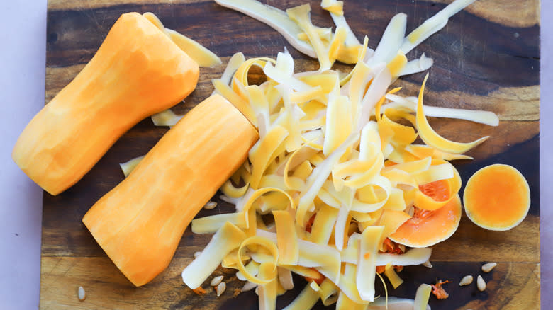 Peeled butternut squash on board