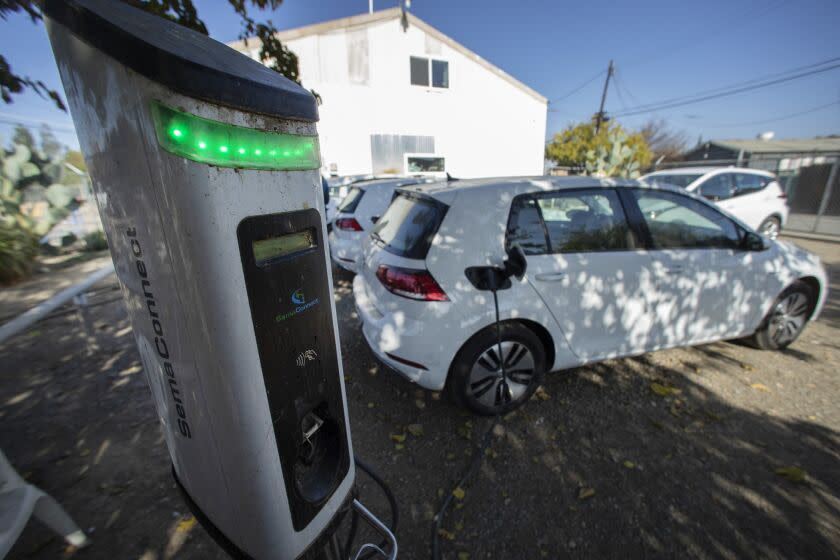 HURON, CA - NOVEMBER 30: The Green Raiteros program in Huron in Fresno County operates out of a former diesel mechanic's shop in town. The innovative electric car ride-sharing initiative provides rides for residents from a small fleet of electric vehicles powered by subsidized charging stations. The state is investing hundreds of millions in this effort, much of the money generated by fees polluters pay under the state climate law, to help promote similar programs and to help change the perception of who can afford electric cars. Photographed on Tuesday, Nov. 30, 2021. (Myung J. Chun / Los Angeles Times)