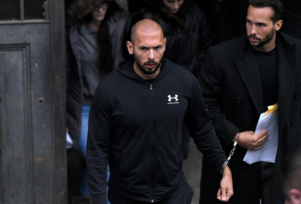 Andrew Tate, center, and his brother Tristan, leave after appearing at the Court of Appeal, in Bucharest, Romania (Copyright 2023 The Associated Press. All rights reserved.)