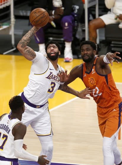 Lakers forward Anthony Davis intercepts a pass intended for Suns center Deandre Ayton during Game 4.