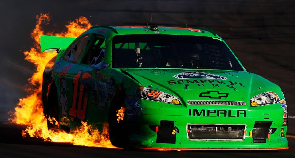 AVONDALE, AZ - NOVEMBER 11: Danica Patrick drives the wrecked #10 GoDaddy.com Chevrolet as flames shoot from the back of her car after an incident in the NASCAR Sprint Cup Series AdvoCare 500 at Phoenix International Raceway on November 11, 2012 in Avondale, Arizona. (Photo by Tom Pennington/Getty Images for NASCAR)