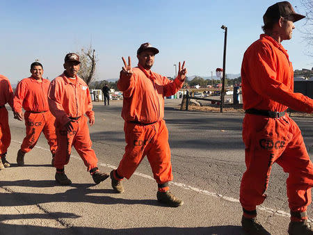 Prison inmates head out to the day’s work of battling the blazes at fire command center in Santa Rosa, California, U.S October 14, 2017. REUTERS/Heather Somerville.